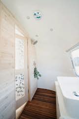 The bathroom walls are clad in whitewashed cedar.