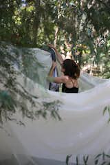 A sheet strung up in the trees offers a private place to undress and change into bathing gear.