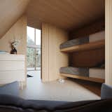 The sleek, wood-clad downstairs bedroom includes built-in bunk beds.