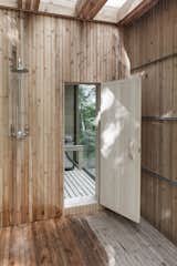 An outdoor cold shower is located on the deck adjacent to the sauna.