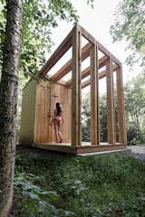 Large wood beams frame the sauna’s deck and outdoor shower area.
