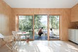 Living Room, Light Hardwood Floor, Wood Burning Fireplace, and Bar The family of three (soon to be four) uses the minimalist-inspired cabin in the Catskills as their peaceful weekend getaway. In the future they hope to build a larger home and turn the cabin into a guest house.  Photos from The Cofounders of Den, a DIY Cabin Startup, Share a Peek Into Their Catskills Retreat