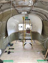 When they purchased the Airstream, it was already gutted, but they had to strip the chassis down further before building out the new interior.  