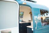 California-based Airstream renovation company Innovative Spaces gave this 1984 triple-axle Excella a complete gut and shell-off renovation for a young family in San Antonio, Texas. The goal was to maximize space in the 34-foot-long trailer and make the Airstream off-grid compatible for weekend getaways and long-term vacations. The exterior of the chassis was updated with a fresh coat of paint in a blue-gray hue inspired by Mercedes-Benz Sprinter vans.