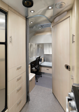 The back corner of the travel trailer is home to the new office space. A partition closes off the area for privacy.