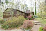 The home’s dated brown exterior and overgrown plantings were in need of some TLC.