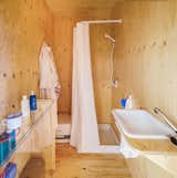 The small bathroom is fully equipped with a shower, sink, and composting toilet.