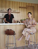 Robert and Cortney Novogratz enjoy a drink at the pool house bar, which was created by Roman Padilla.