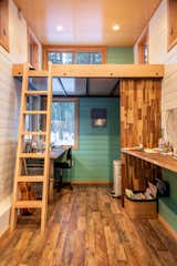 Walls are covered in 6-inch pine shiplap siding and painted in a creamy white and soothing green. Ceilings are clad in finished birch and the space is trimmed in D grade fir to keep costs down.