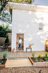 Kelli Hix added this 500-square-foot guesthouse to the back of her 1930s bungalow in Nashville, Tennessee.&nbsp;The guesthouse is clad in vertical white vinyl siding, and Kelli had decking constructed out of engineered wood and cedar.
