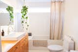 “I pulled in other vintage pieces to give the space some soul,” Kelli says. A salvaged door was added to the bathroom and brass drawer pulls from ebay were added to the vanity.