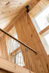 In lieu of a traditional railing that would obstruct views, a nautical rope railing was installed to easily allow them to bring larger furnishings and items into the loft.