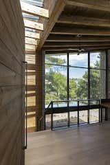 The entrance opens up to the whole interior enclosure, immediately as someone enters, surprising the visitor to the house’s unpredictable nine-meter-height interior