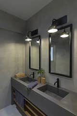 Bath Room, Concrete Counter, Ceramic Tile Floor, Wall Lighting, and Stone Tile Wall Children's bathroom  Photo 15 of 21 in Harmony Apartment Renovation by Marianna Athanasiadou