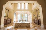 Bath Room Master Bathroom: Find a true pièce de résistance in the master suite, where a two-story closet sits in perfect accompaniment to the island soaking tub and walk-through shower.  Photo 7 of 12 in 5139 Fairway Oaks Drive by Mary Kate Morrow