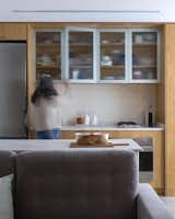 Kitchen, Engineered Quartz Counter, Ceiling Lighting, Refrigerator, Wall Oven, Concrete Floor, Wood Cabinet, Quartzite Counter, Cooktops, and Concrete Backsplashe Kitchen  Photo 6 of 14 in DEL SIGNO APARTMENT by Fallone Studio