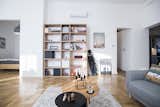 Living Room, Sofa, Bookcase, Coffee Tables, Table Lighting, Pendant Lighting, and Light Hardwood Floor Martin's home hides and shows plenty of tools like a golf kit, mountain bike or a ski  Photo 6 of 15 in Fusion of Modern Minimalism and Family Heritage by Studio Bunyik