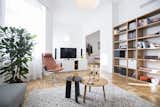 Living Room, Coffee Tables, Bookcase, Sofa, Chair, Pendant Lighting, Wall Lighting, and Light Hardwood Floor  Photo 1 of 15 in Fusion of Modern Minimalism and Family Heritage by Studio Bunyik