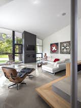 The living room features an Eames lounge chair and ottoman from Design Within Reach and original artwork by Bill Snider