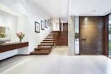 View of foyer and stairs to loft at Residence 1446 by Miró Rivera Architects