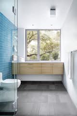 Finishes such as exposed concrete and playful tile accents denote the more laid-back, intimate atmosphere.