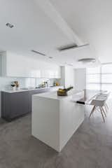 Beautiful modern kitchen , with concrete floor , amazing wooden table designed by Nathalie milazzo