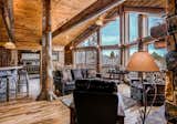 Living Room, Sofa, Chair, Coffee Tables, Ceiling Lighting, Table Lighting, Accent Lighting, Wall Lighting, Pendant Lighting, and Dark Hardwood Floor  Photo 2 of 15 in A Modern Approach To The Rustic Log Home by Golden Eagle Log & Timber Homes