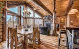 Dining Room, Medium Hardwood Floor, Chair, Table, Ceiling Lighting, Wall Lighting, Pendant Lighting, and Stools  Photo 14 of 15 in A Modern Approach To The Rustic Log Home by Golden Eagle Log & Timber Homes