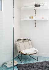 Dandelion cement tiles from Marrakech Design adorn the master bathroom. The chair is from Lawson Fenning.&nbsp;