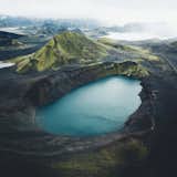 A massive crater lake in Iceland—see the tiny white car for scale.
