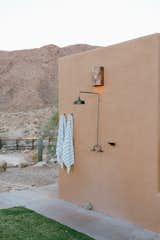 An outdoor shower welcomes Young home after a day out in the dunes.