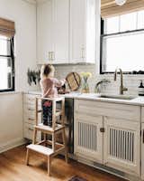 To allow for their two-year-old to be more involved in kitchen happenings, they built a toddler stool. The IKEA stool has a DIY topper frame to keep Sylvia from teetering off.