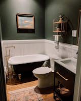 In this bathroom, the couple installed new flooring, swapped the shower stall for a tub, put in a new vanity, and updated the walls with tile and paint.