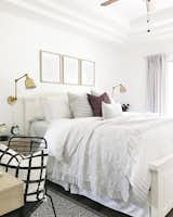 The bedroom is airy but cozy. Wrinkly sheets are a "problem" that Hartley gives "zero care units" about. Adding a pop of color is a plum-hued pillow from Motif Pillows on Etsy.