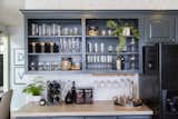 Open shelving provides a rustic touch and a place to store some of the family's beautiful kitchenware.&nbsp;