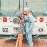 Chase and Mariajosé in front of their bus.