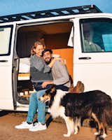 The lovebirds and Cleo in front of the van.