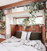 Bedroom, Shelves, and Bed Morris' bedroom exudes all the cozy vibes with plants and a pure linen coverlet from Rough Linen.  Photos from 10 Tiny Home Dwellers You Should Follow on Instagram Right Now