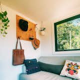 A pegboard makes for stylish storage next to a large window with wooded view.