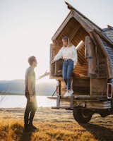 Exterior, Wood, Shingles, Tiny Home, A-Frame, Cabin, and Camper Witzling and Underwood stepping out of the truck cabin.  Exterior Tiny Home Shingles Cabin Wood Photos from 10 Tiny Home Dwellers You Should Follow on Instagram Right Now