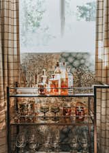 "I felt like an epic bar cart needed to make an appearance somewhere, and the den-like quality of the game room felt like just the place. I used the Brixton bar cart from Room &amp; Board and filled it with some of my favorite vintage pieces as well as some new ones from West Elm. The copper Moscow Mule mugs are necessary for a cabin weekend."