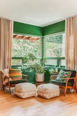The green hue permeates her space, including this boho sitting area. 