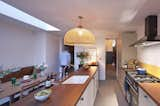 The spacious new kitchen flows with an open floor plan and neutral palette. IKEA cabinets were "hacked" with custom fronts.