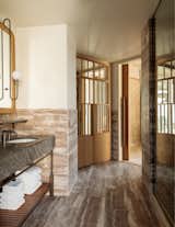 The Zen-like bathrooms are cloaked in stone and wood.