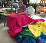 Gilbert Baker sewing a rainbow flag