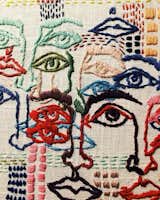 A close up of Tessa Perlow's embroidered faces.