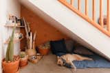 Joey’s hideout under the stairs is filled with books and art, like Katie Gong’s mini wood knot.