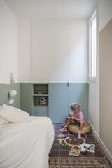 The children’s room has a built-in wardrobe that follows the wall colors.&nbsp;