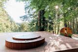 The Northern Lights outdoor hot tub and sauna top off this wooded retreat.&nbsp;