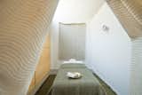 Four minimalist treatment rooms are carved out for table massages.&nbsp;